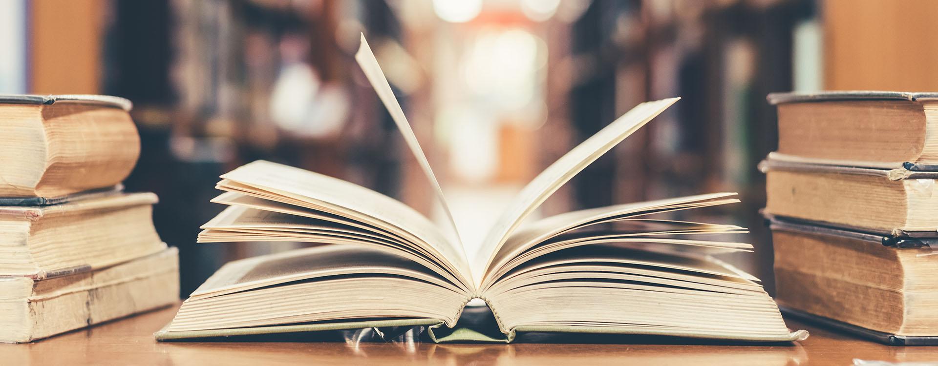 Open old book on a table in a library